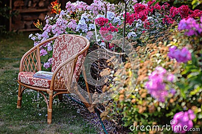 Chair in blooming summer garden Stock Photo