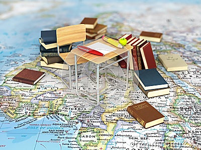 Chair and desk with books on the world map. Stock Photo