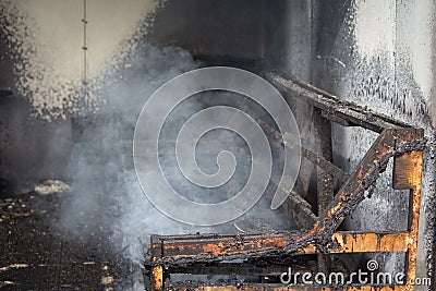 Chair and furniture in room after burned in burn scene of arson Stock Photo