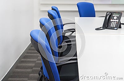 Chair with IP phone on white meeting table in office Stock Photo