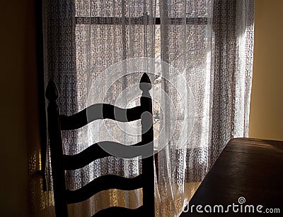 Chair and lace curtains, window light Stock Photo