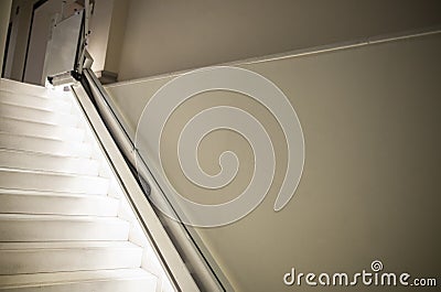 Chair lift for disabled people with illuminated steps Stock Photo