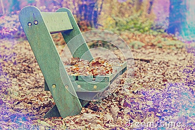 Chair in park under leaves with lens flare effect. Vintage tone Stock Photo