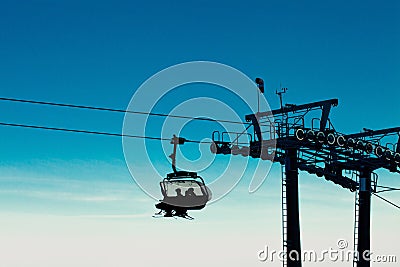 Chair ski lift with skiers going up Stock Photo