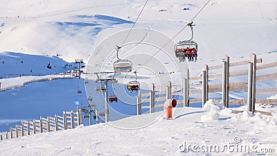 Chairlift and wooden fence at Cota 2000, Sinaia ski domain, Romania, on a sunny Winter day Editorial Stock Photo