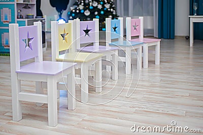 Chairs in children`s room. Kids room Interior. Chairs in kindergarten preschool classroom. Many brightly colored chairs for Stock Photo