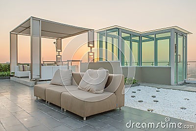 Chairs and a couch provide a place from a highrise rooftop Stock Photo