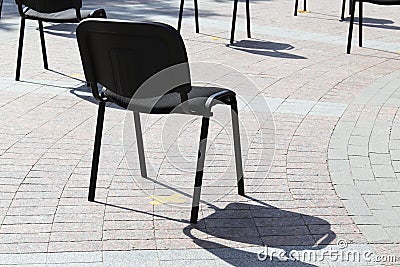 Chairs on the street are arranged in rows at a distance, keep your distance, quarantine measures Stock Photo
