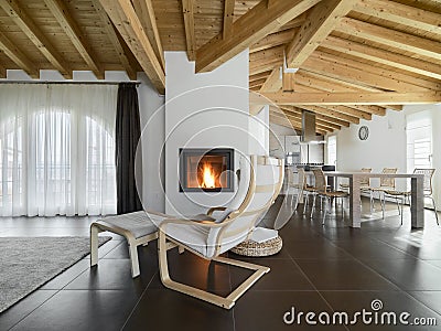 Chaise longue near to fireplace in a living room Stock Photo