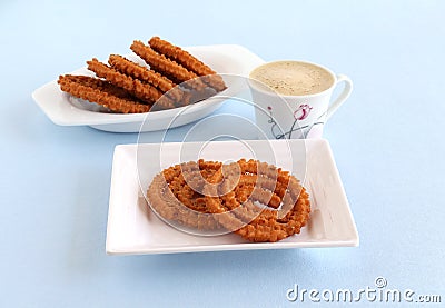 Chakli Indian Savory Snack on a Plate and Coffee Stock Photo