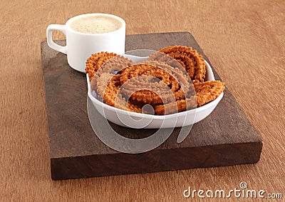 Chakli Indian Savory Snack in a Tray and Coffee Stock Photo