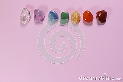 Chakra healing stones on pink millennial background Stock Photo