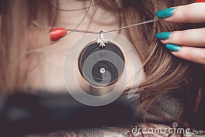 Chakra medallion hanging on the woman`s Breasts Stock Photo