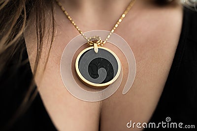 Chakra medallion hanging on the woman`s chest Stock Photo