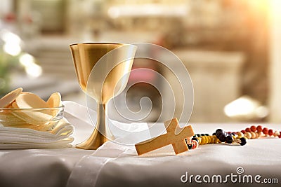 Chalice and consecrated host on table at the altar Stock Photo