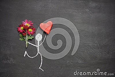 Chalk drawing man with bouquet of flowers and big red heart on chalkboard background with copy space. Valentines day gift or Stock Photo