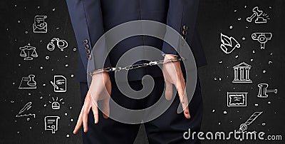 Symbols of courthouse with handcuffed man Stock Photo
