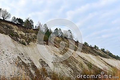 Chalk structure on artificial mountain after quarry mining. Technogenic rock formed during mine. Mountain hill with chalk fossil Stock Photo