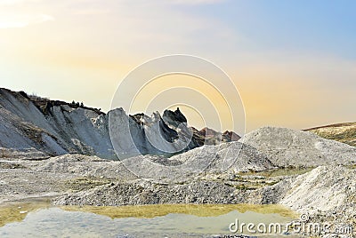 Chalk structure on artificial mountain after quarry mining. Technogenic rock formed during mine. Mountain hill with chalk fossil Stock Photo