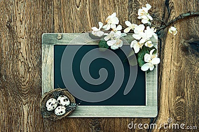 Chalkboard with apple tree blossom, easter eggs Stock Photo