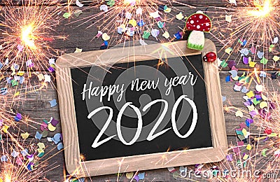 Chalkboard with four leaf clover and chimney sweeper and sparklers with happy new year 2020 Stock Photo