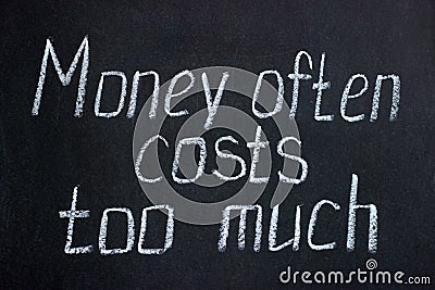 Chalkboard lettering Money often costs too much Stock Photo