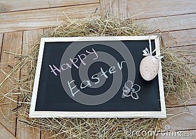 Chalkboard with text Happy Easter and Decorative egg Stock Photo