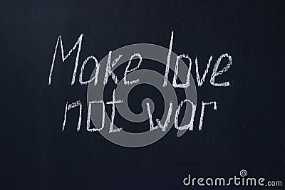 Chalkboard text Make love not war. Life-affirming and pacifist lettering Stock Photo