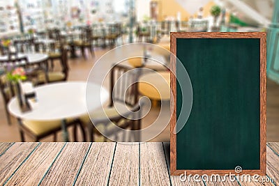 Chalkboard wood frame blackboard sign menu on wooden table. Stock Photo