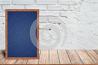 Chalkboard wood frame, blackboard sign menu on wooden table and with brick background. Stock Photo