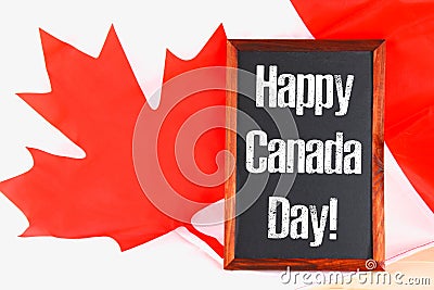 Chalkboard with the word Happy Canada Day on the national flag. Feast of 1 July. Stock Photo