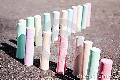 Chalks for painting stand on the asphalt Stock Photo