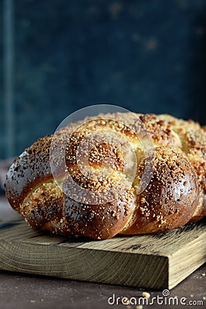 Challah or Hala is a traditional jewish sweet fresh sabbath bread loaf, fresh bun on cutting board. Brioche bread on breakfast Stock Photo