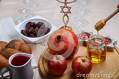 challah, wine, apple dates and honey on a wooden round board for Rosh hashanah celebration. Stock Photo