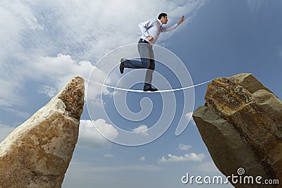 Challenge concept. Man walking on wire Stock Photo