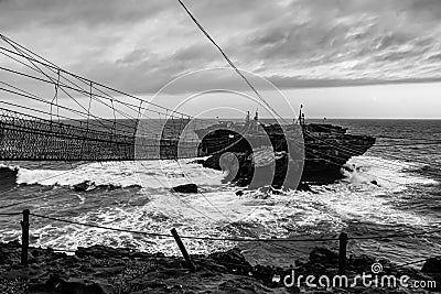 Challenge on swinging rope foot bridge and cable car to a rock island Editorial Stock Photo