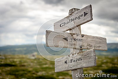 Challenge your faith engraved text on wooden signpost Stock Photo