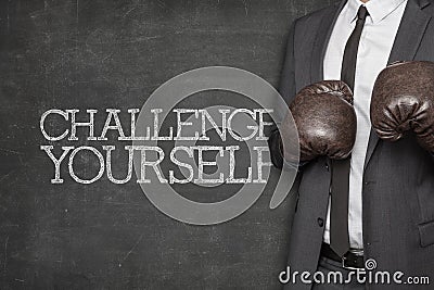 Challenge yourself on blackboard with businessman Stock Photo