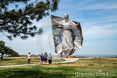 People gather around the Dignity Statue in a Chamberlain rest area, a tribute to the Editorial Stock Photo