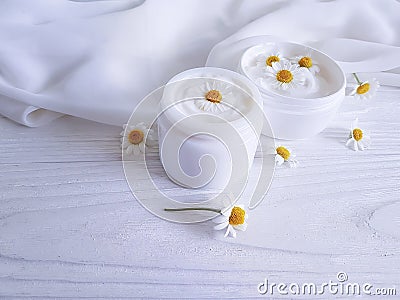 Chamomile , cosmetic beautiful freshness cream facial on a white wooden background Stock Photo