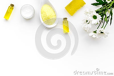 Chamomile spa cosmetics with natural herbal ingredients. Chamomile spa salt, soap, oil and cream on white background top Stock Photo