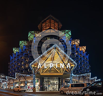 Chamonix, France - December 28, 2018: Alpina hotel in the evening with colourful lights on Editorial Stock Photo