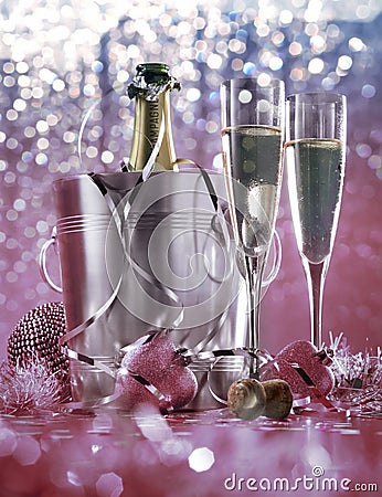 Champagne bottle in bucket with ice and glasses of champagne on dark background. Celebration theme with champagne Stock Photo