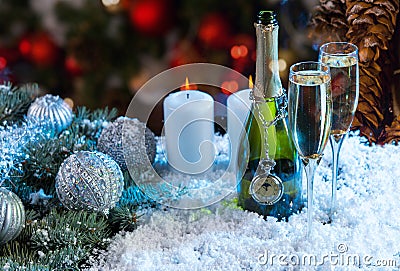 Champagne and Candles on Festive Snowy Surface Stock Photo