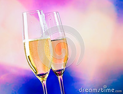 Champagne flutes with golden bubbles on blur decorative hearts background Stock Photo