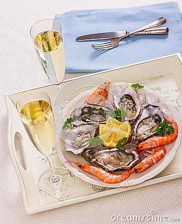 Champagne glasses, oysters shell with shrimp on serving tray Stock Photo