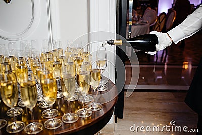 Man pours champagne in wineglasses Stock Photo