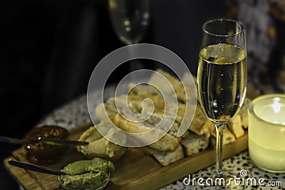 Champagne served with sliced focaccia with different spreads Stock Photo