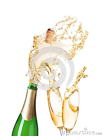 Champagne splashing out of bottle and glasses on background Stock Photo