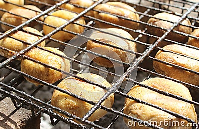 Champignon mushrooms are grilled. Fry mushrooms on a homemade stone grill. Stock Photo